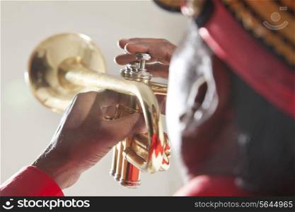 Close-up of hands playing a trumpet