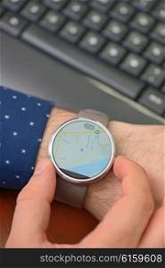 Close up of hands with map on smartwatch