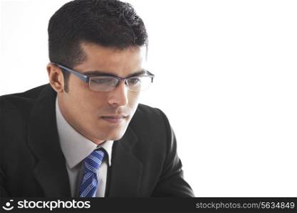 Close-up of handsome businessman contemplating over white background