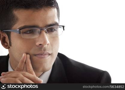 Close-up of handsome businessman contemplating over white background