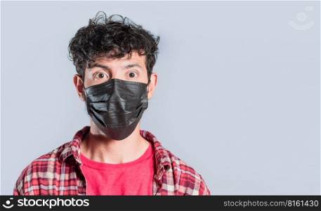 Close-up of handsome guy wearing protective mask, Close up of latin person wearing surgical mask isolated, Close-up of person wearing surgical mask on isolated background