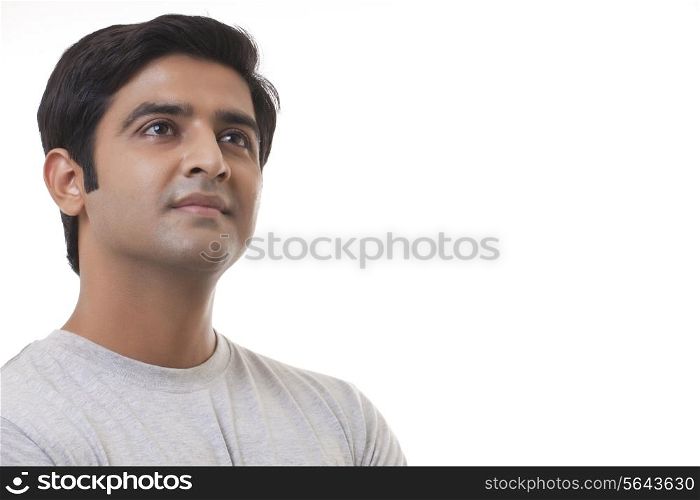 Close-up of handsome man thinking over white background