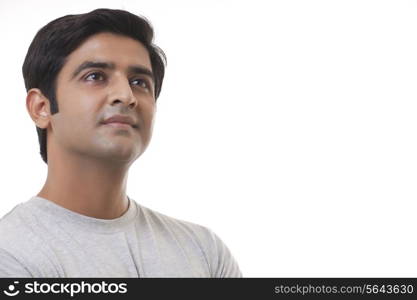 Close-up of handsome man thinking over white background