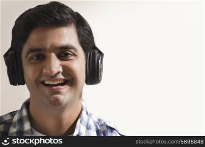 Close-up of handsome young guy listening music