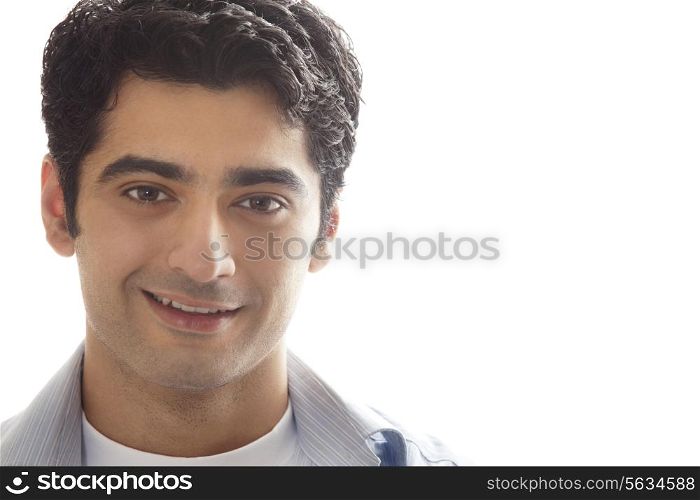 Close-up of handsome young man smiling over white background