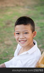 Close up of happy asian boy smiling in green garden. asian boy smiling