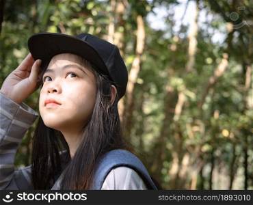 Close-up of happy young Asian woman explorer wearing backpack.