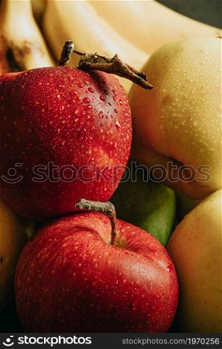 Close up of healthy still life fruits with a very delicious aspect apples and bananas with water drops