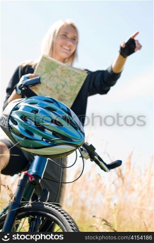 Close-up of helmet mountain biking young woman search in map