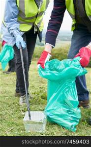 Close Up Of Helpful Senior Couple Collecting Litter In Countryside