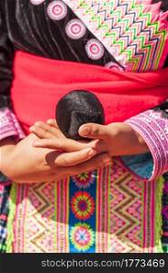 Close-up of Hmong tribal girl&rsquo;s hands holding weave cotton rope ball while playing a ball-throwing game in Hmong New Year&rsquo;s celebration in North Thailand.