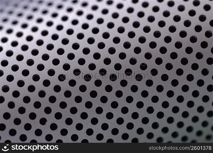 Close-up of holes on a metallic surface