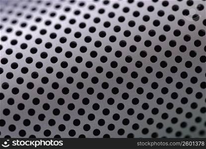 Close-up of holes on a metallic surface