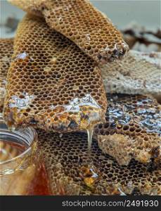 Close-up of Honey drop with overlapping Fresh honeycombs. Healthy organic natura honey, space for text, Selective focus.