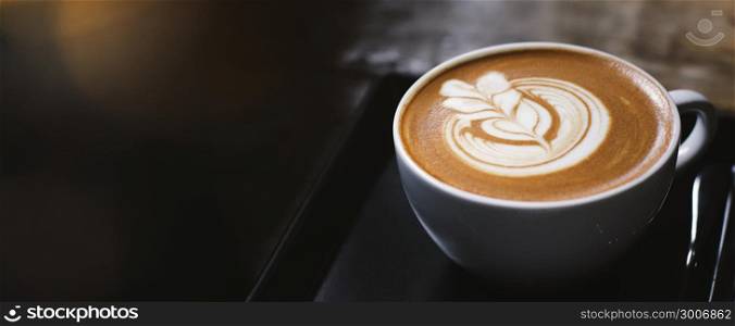 Close up of hot latte coffee in the cafe, photo banner for website header design with copy space for text