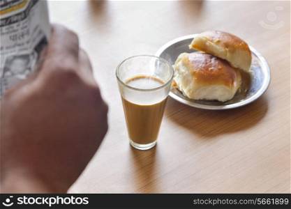 Close-up of hot tea and pav on table