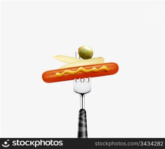 close up of hotdog and baby corn and olive pierced by fork, isolated on white background