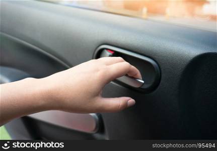Close up of human female hand opening car door