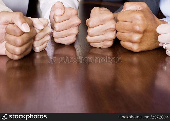 Close-up of human fists on the table