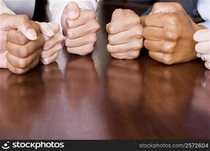 Close-up of human fists on the table