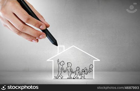 Close up of human hand drawing happy family and real estate concept. House of your dream