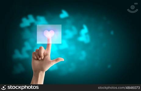 Close up of human hand pushing icon of media screen. Heart icon