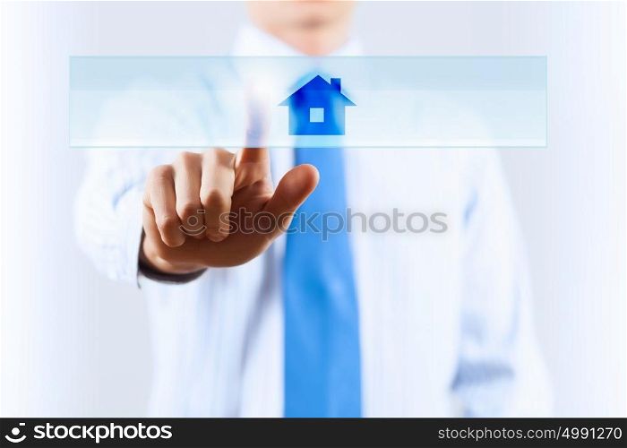 Close up of human hand touching icon with finger. Home icon