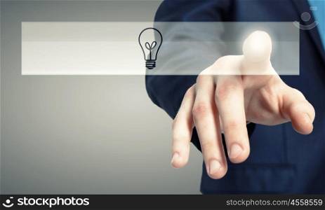 Close up of human hand touching icon with finger. Light bulb icon