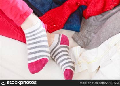 Close up of human woman feet in striped socks.. Close up of human woman feet in colorful striped socks.