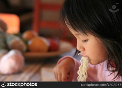 close up of hungry child eating pasta