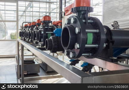 close-up of in a row of plastic pipes and water pumps. industrial pipes and engine