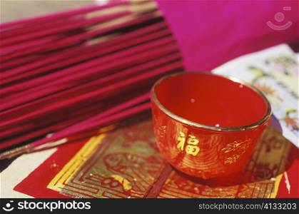 Close-up of incense sticks and a bowl