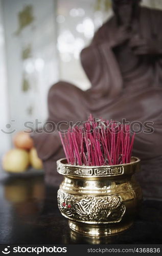 Close-up of incense sticks in a jar