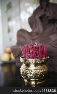 Close-up of incense sticks in a jar