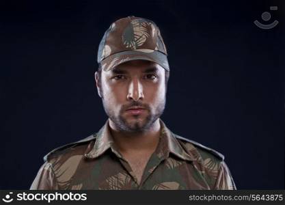 Close-up of Indian soldier over black background