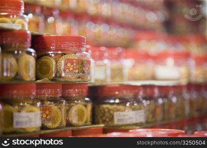 Close-up of jars of pineapple tarts in a store