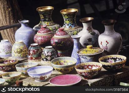 Close-up of jars with bowls and a plate in a store