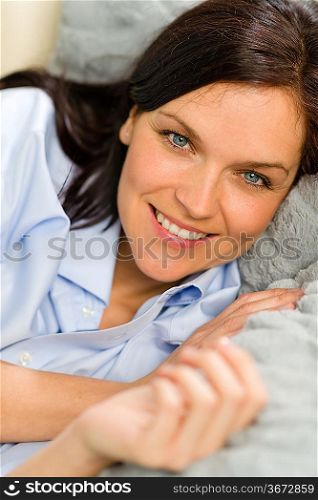 Close up of joyful woman resting on pillows