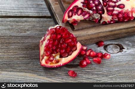 Close up of juicy ripe pomegranates vintage wood