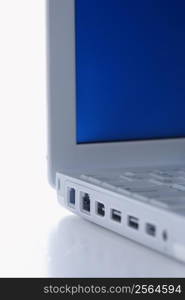 Close-up of laptop computer with no cables plugged in.