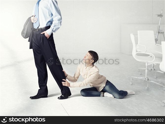 Close up of legs of husband going away and his wife praying him to stay