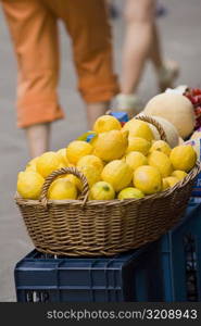 Close-up of lemons in a wicker basket at a market stall, Italian Riviera, Cinque Terre National Park, Vernazza, La Spezia, Liguria, Italy