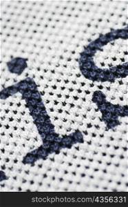Close-up of letters on a woolen fabric