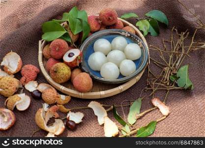 Close up of litchi fruit or lychee fruits, a tropical agriculture product at Luc Ngan, Bac Giang, Vietnam, basket of Vai thieu on brown background