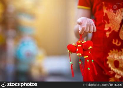 Close-up of little Asian woman wearing red traditional Chinese cheongsam decoration hold Small lantern decorations for Chinese New Year