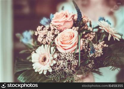 Close up of lovely flowers bunch with Gerbera, roses and green leaves in female hand