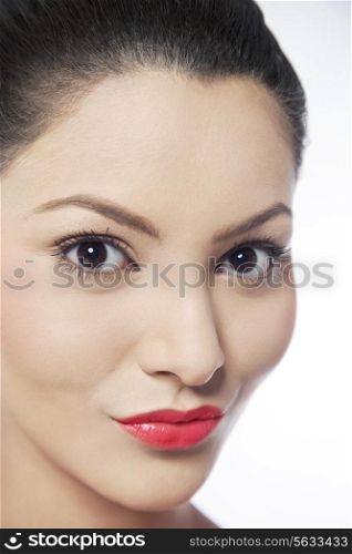 Close-up of lovely young woman over white background