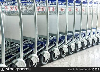 Close up of luggage carts at modern airport interior