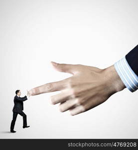 Close up of male businessman. Close up of male businessman pointing at miniature of man