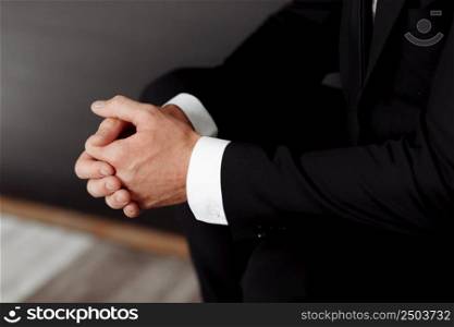 Close up of male clasped hands clenched together, businessman preparing for job interview, concentrating before important negotiations, thinking or making decision, business concept.. Close up of male clasped hands clenched together, businessman preparing for job interview, concentrating before important negotiations, thinking or making decision, business concept